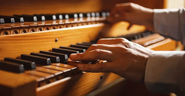 Closeup of a man playing a church organ