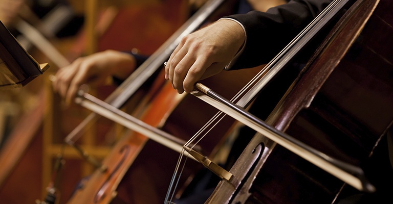 Closeup of cello musicians performing