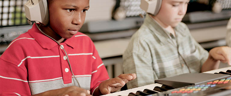 Student playing on keyboards