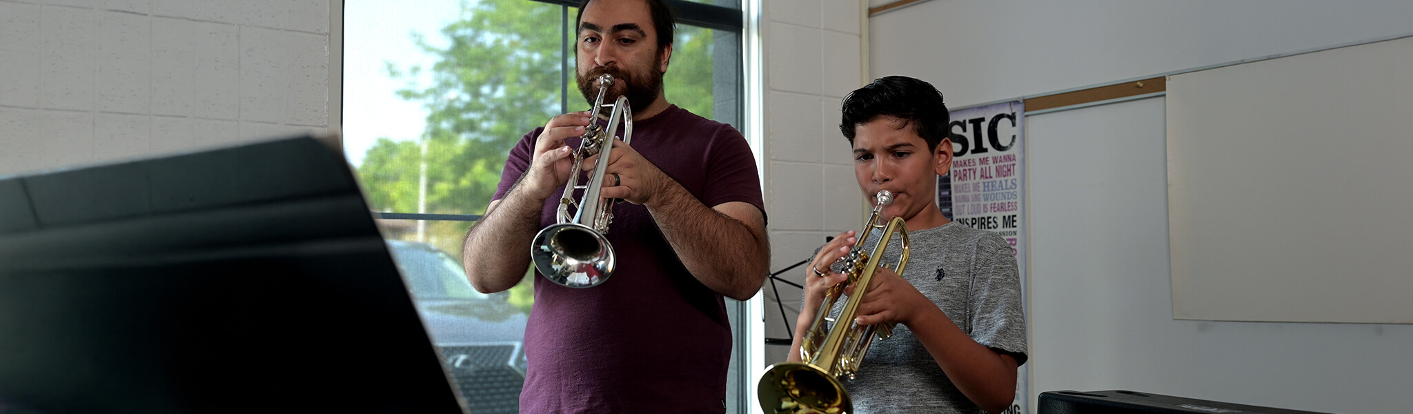 Instrcutor teaching student trumpet